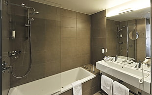 white ceramic bath tube and shower stall